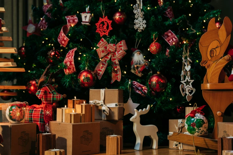 several christmas ornaments, with presents underneath a decorated christmas tree