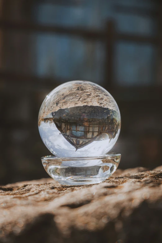 a glass bowl filled with a water drop