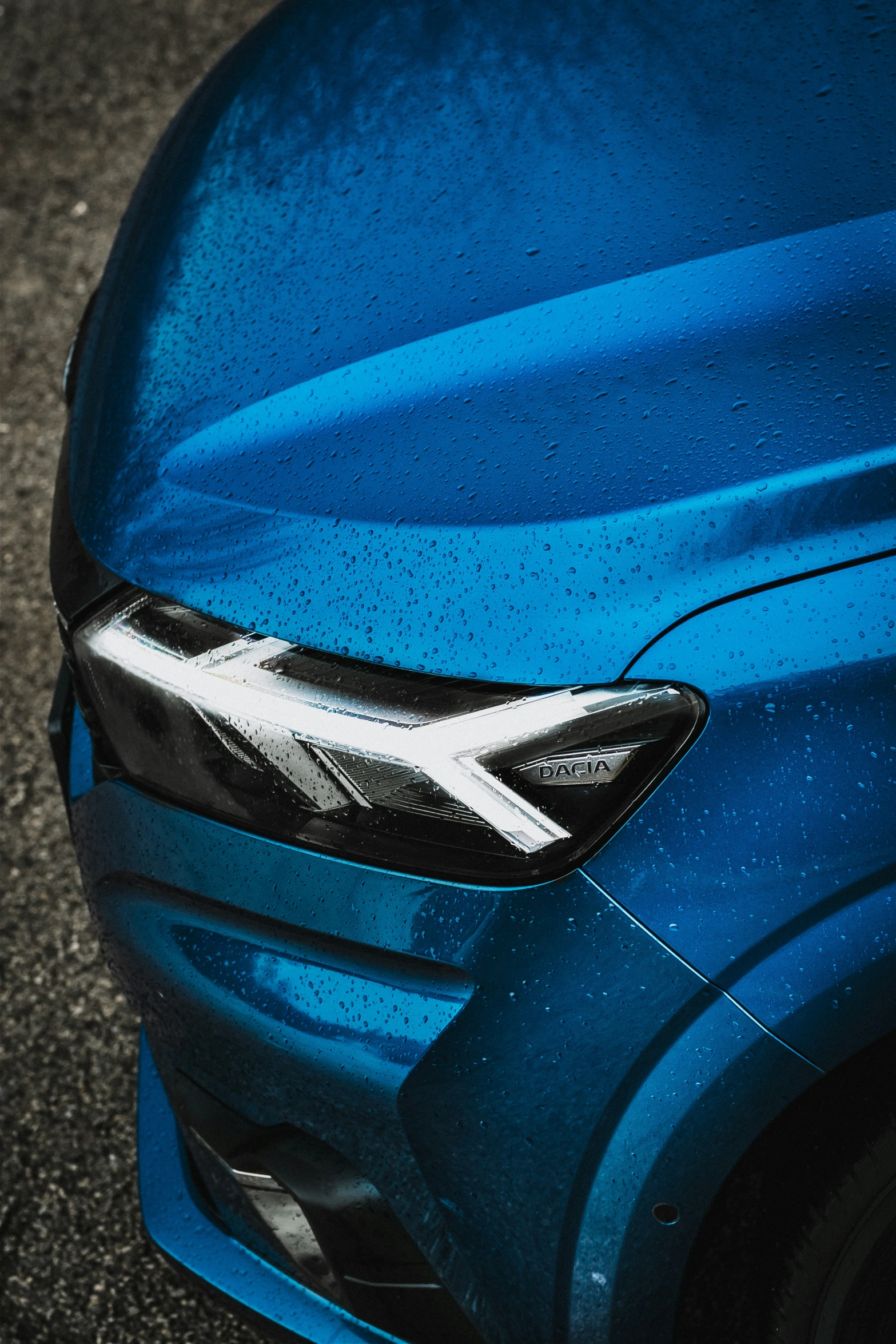 a closeup of the head of a blue car