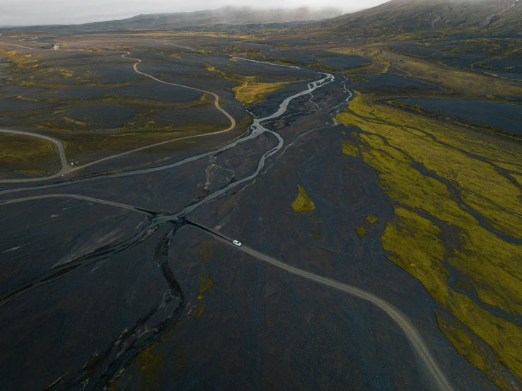 an aerial view of a road through some very brush