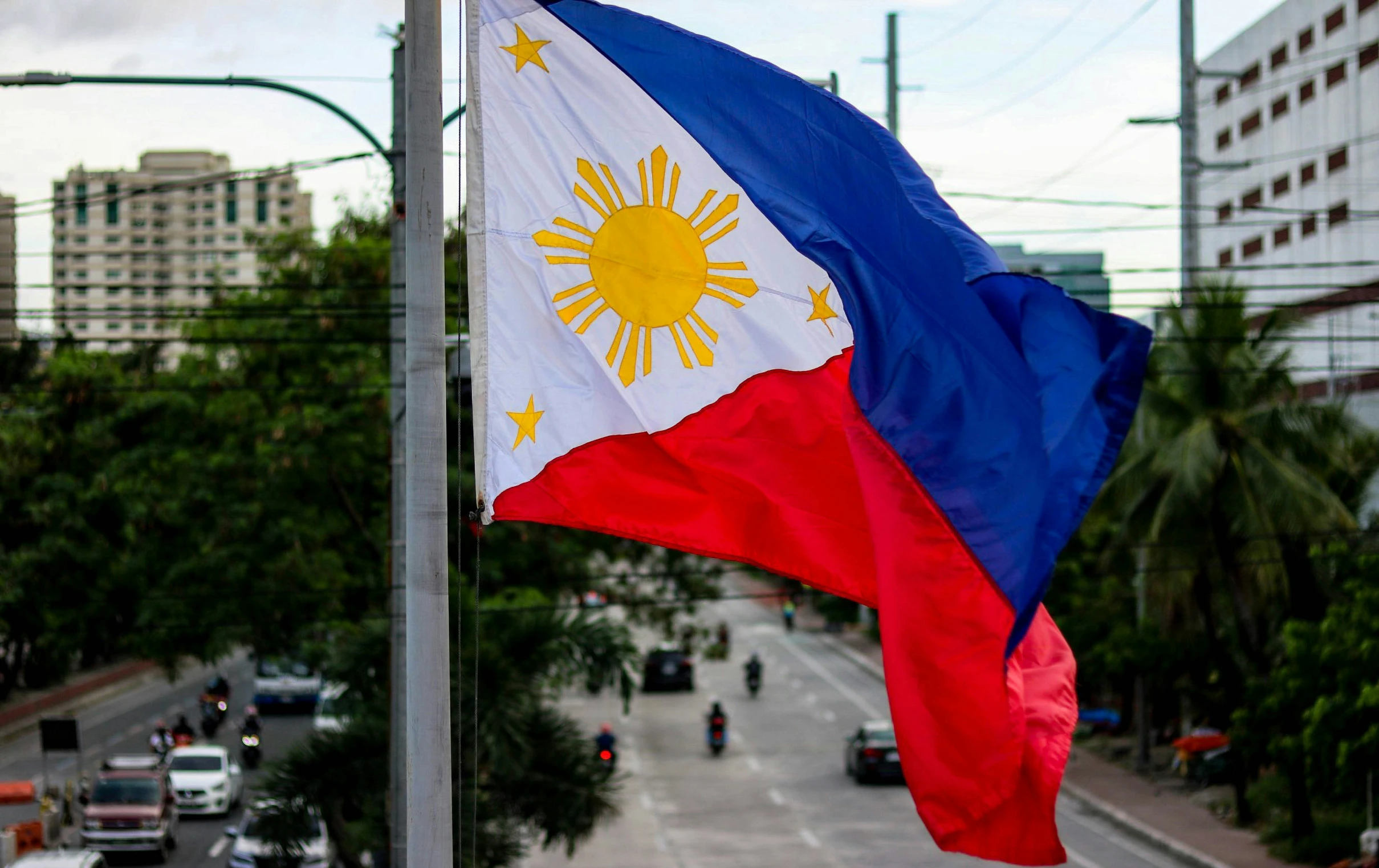 there is a blue, red and white flag on top of a pole