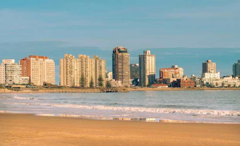 a cityscape by the ocean with tall buildings