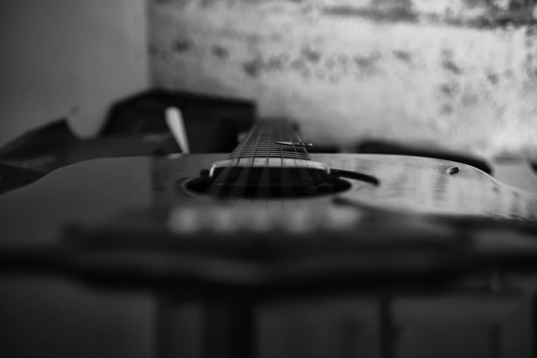 an acoustic guitar laying on top of a table