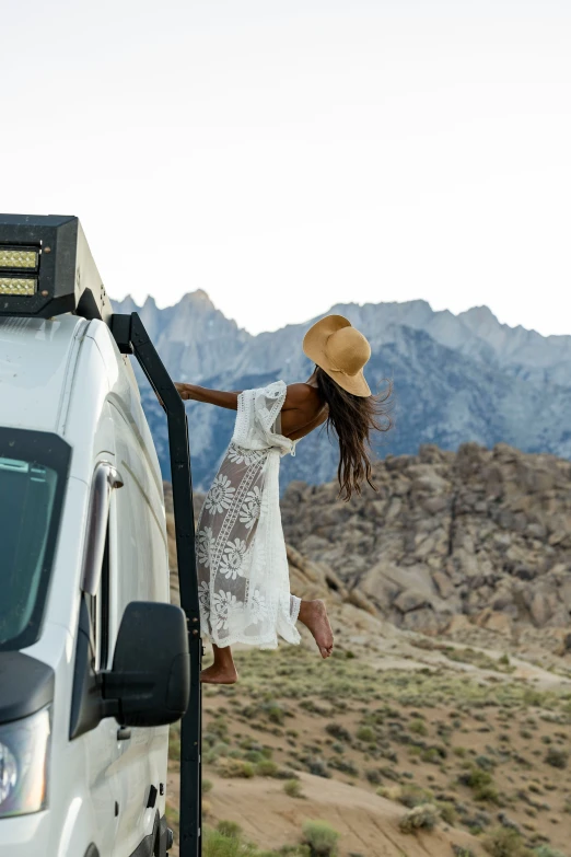 the young woman is walking toward the van