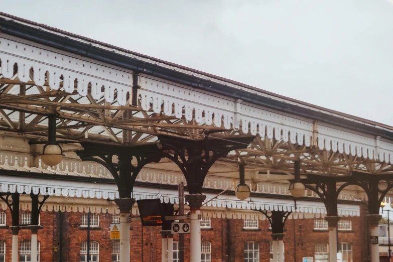 a train station with lots of benches under the roof