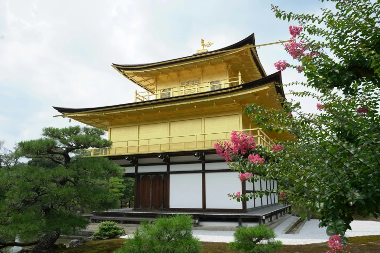 the tall yellow building is on top of a hill