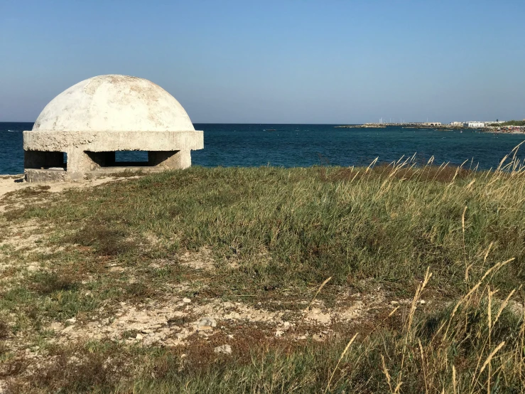 there is a white dome sitting on the beach