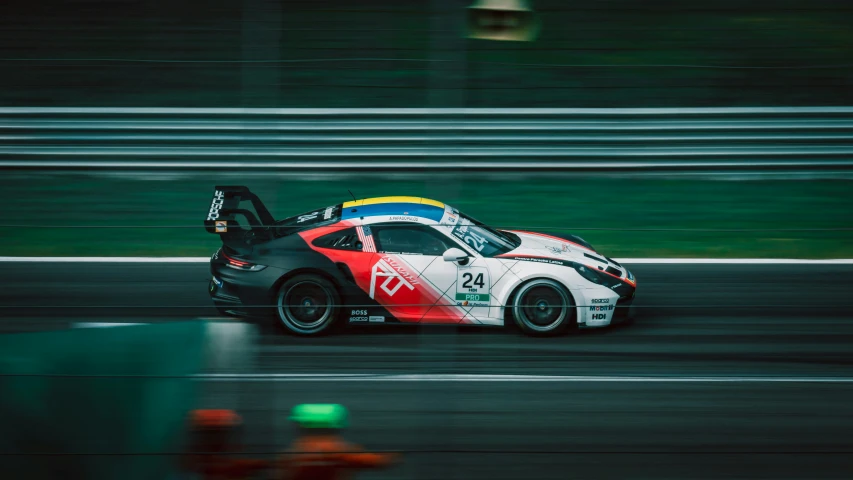 a racing car driving on a track during the day