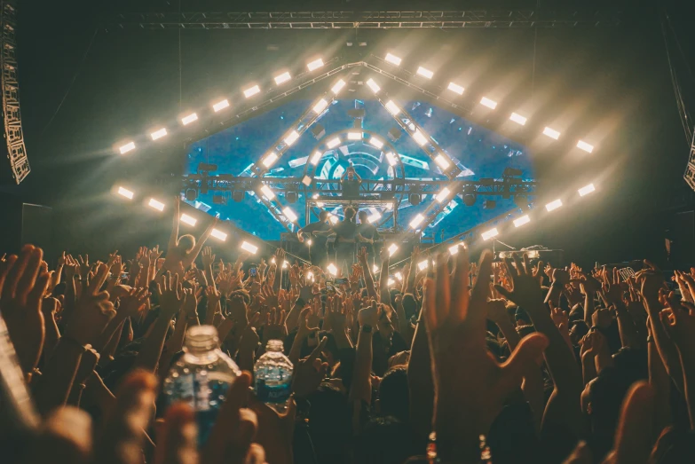 large crowd at a rock and metal festival waving their hands in the air