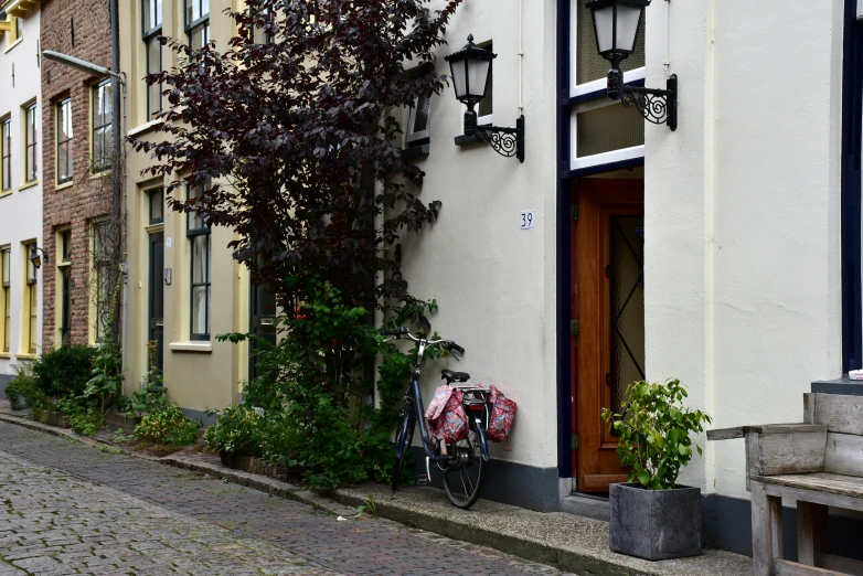 a red bicycle is parked outside of a house