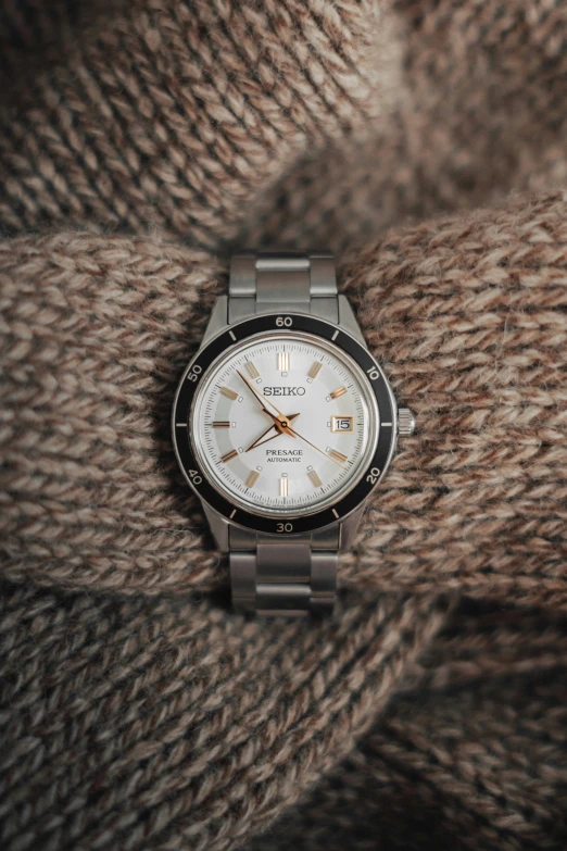 an older model watches sitting on some sort of cloth