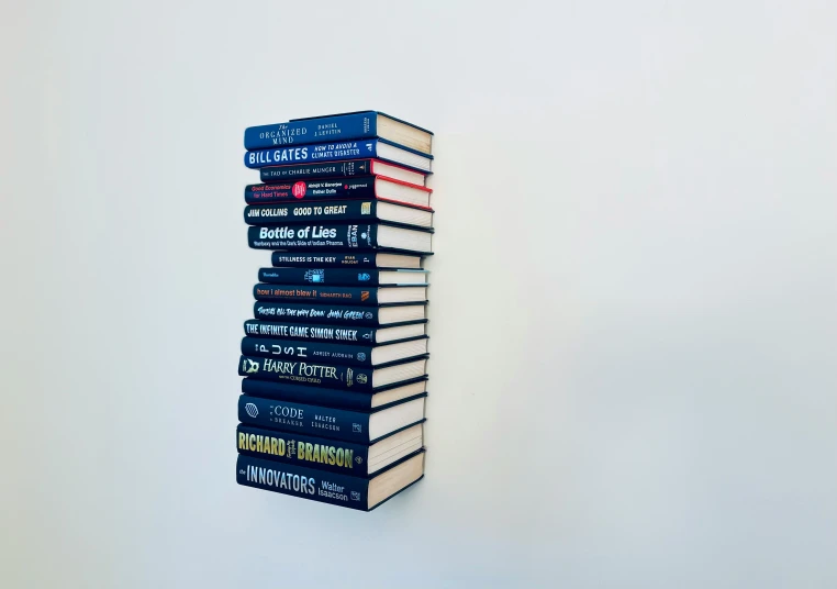 five stack books are placed neatly on a wall