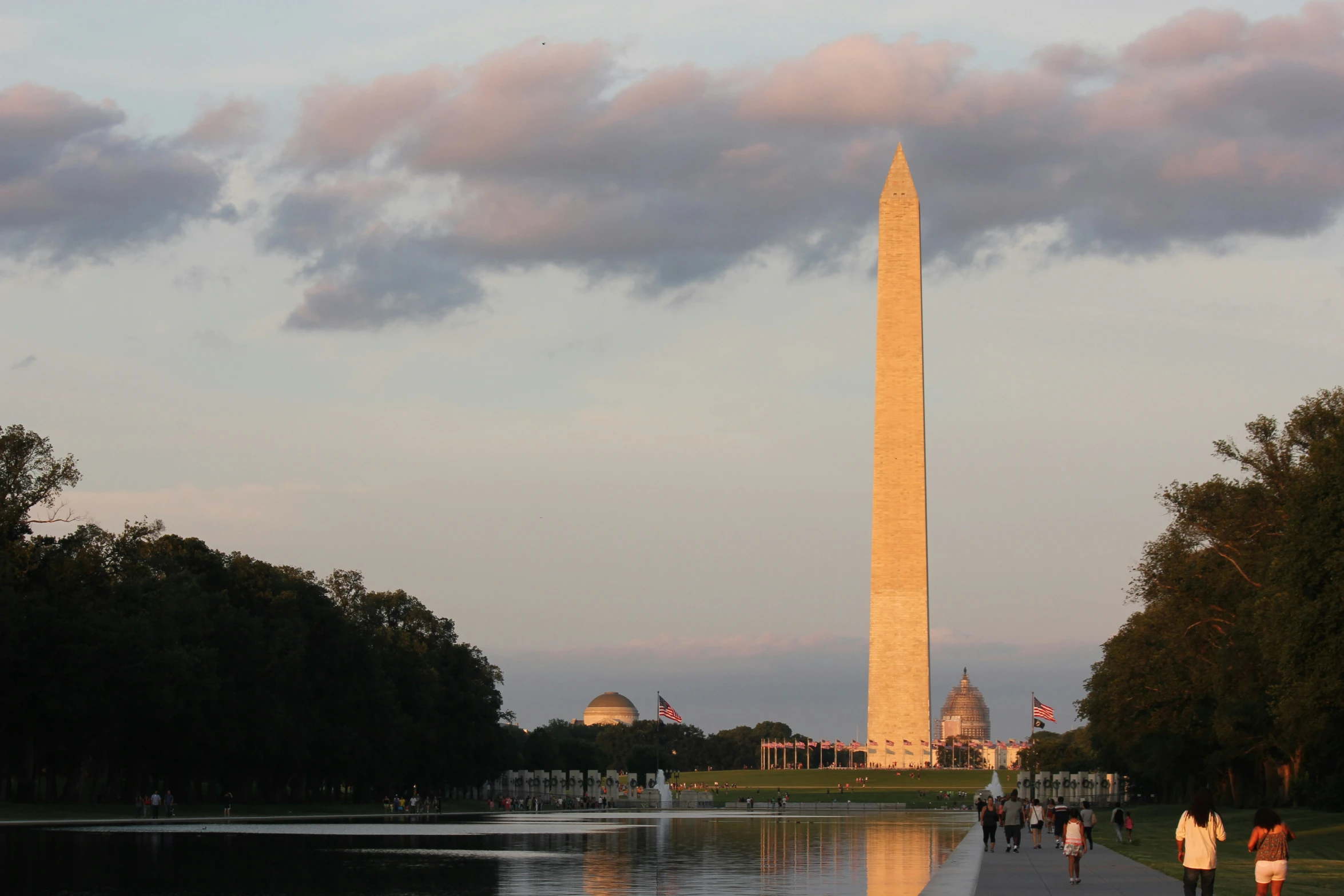 the washington monument is seen in front of the reflecting water