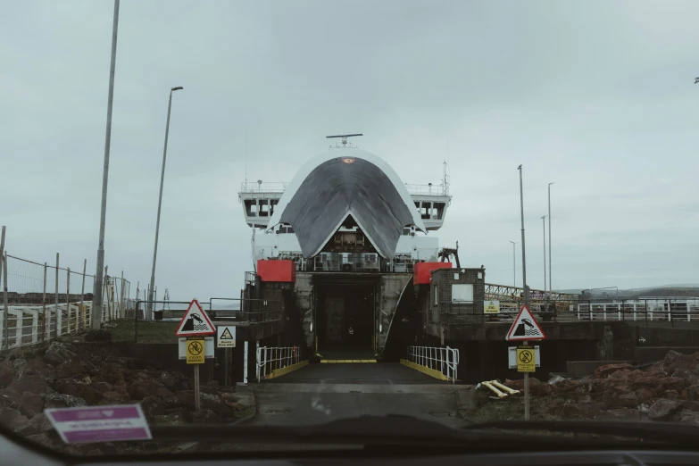 a car sitting in front of a gate with lights