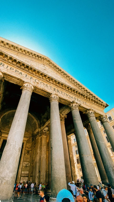 tourists at the entrance to the roman temple in paris