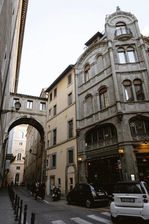 a building with an arched doorway and cars parked