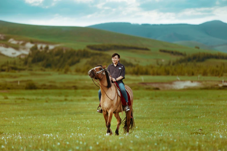 a man is riding a horse through a field