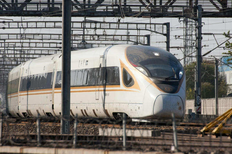 this silver and orange train has yellow lettering on it