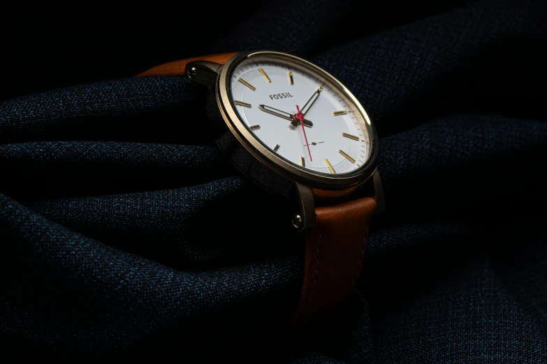 a close up of a watch with a dark background