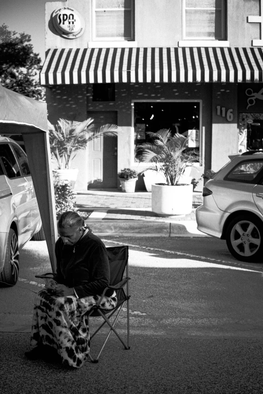 a woman in leopard pants sitting on top of a lawn chair