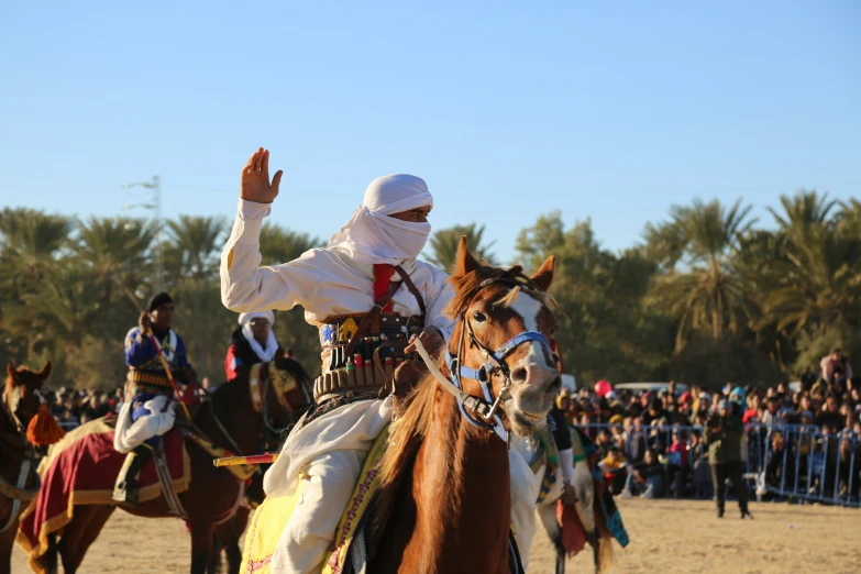 a group of people riding on top of horses