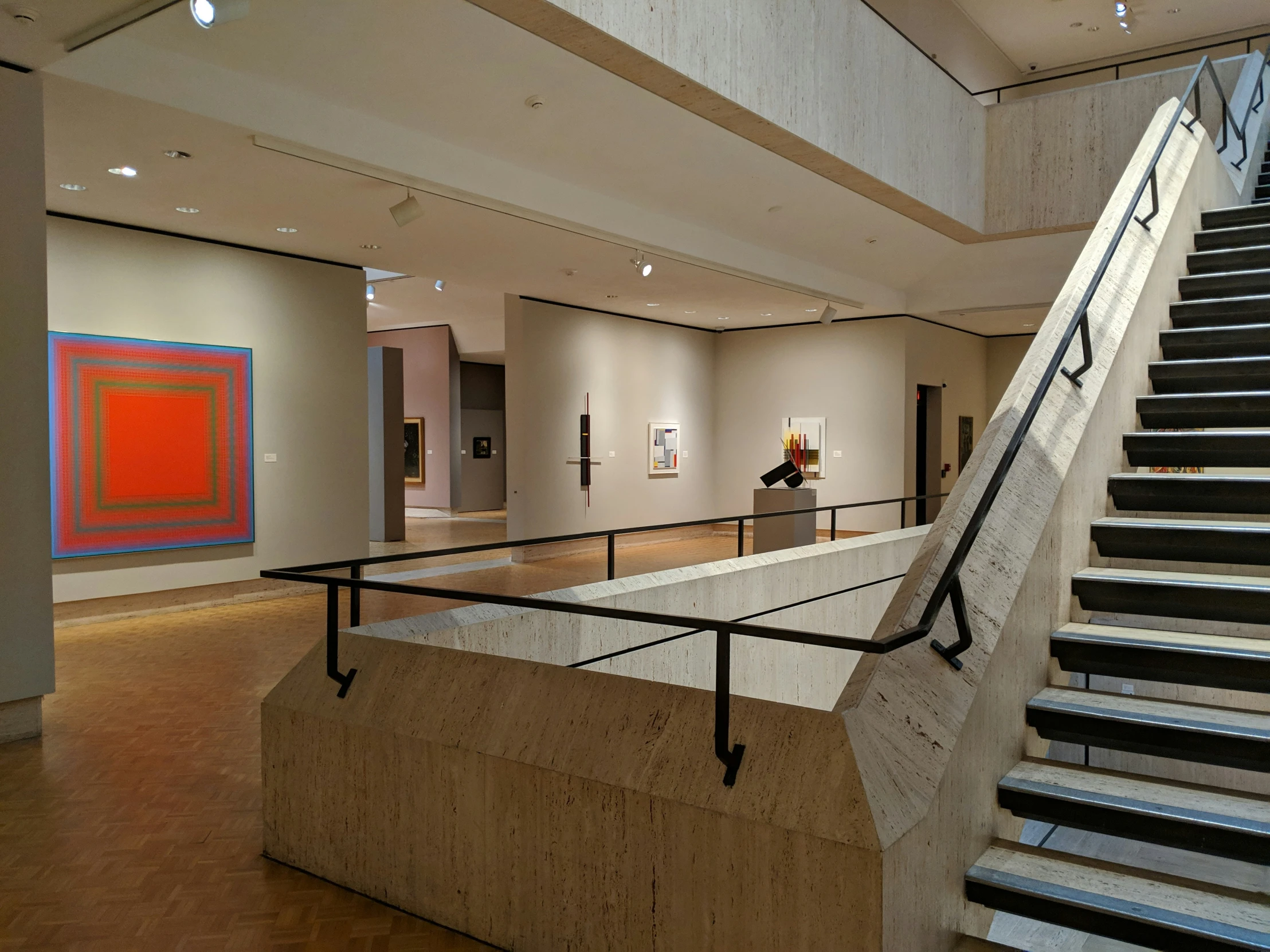 a painting is displayed behind some railings