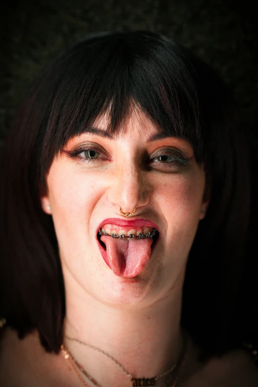 a woman with her tongue out making weird faces