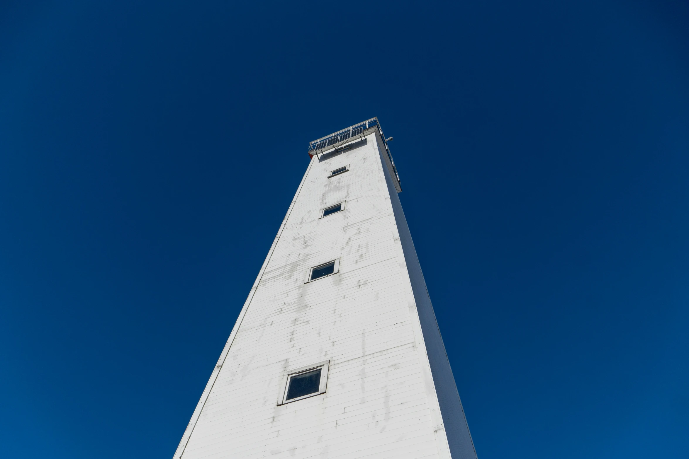 the view from below of a very tall clock tower