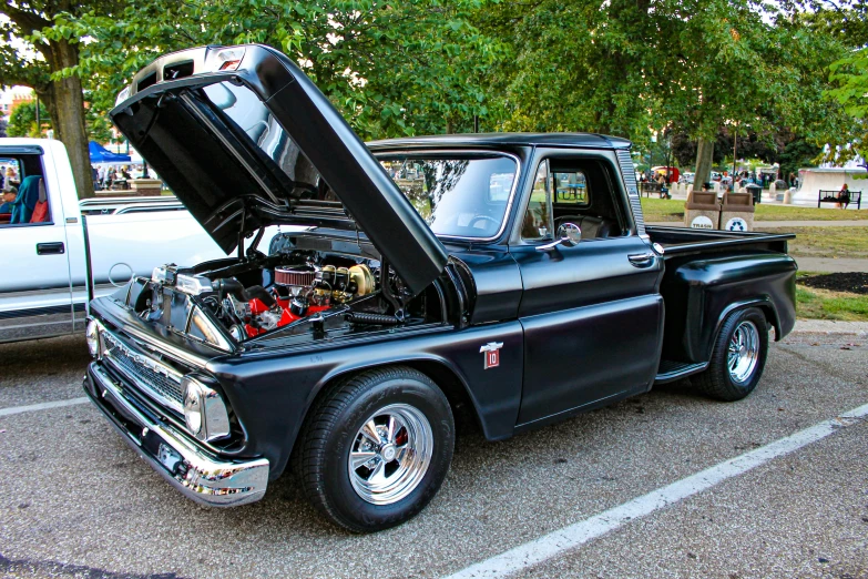 a black pick up truck with the hood open