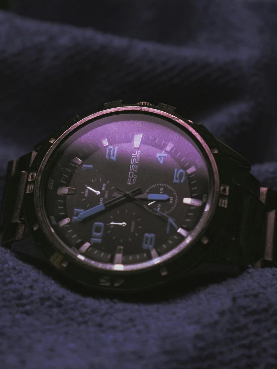 the automatic watch with the black dial has pink numbers