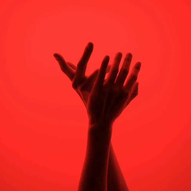 a person reaching up with both hands out