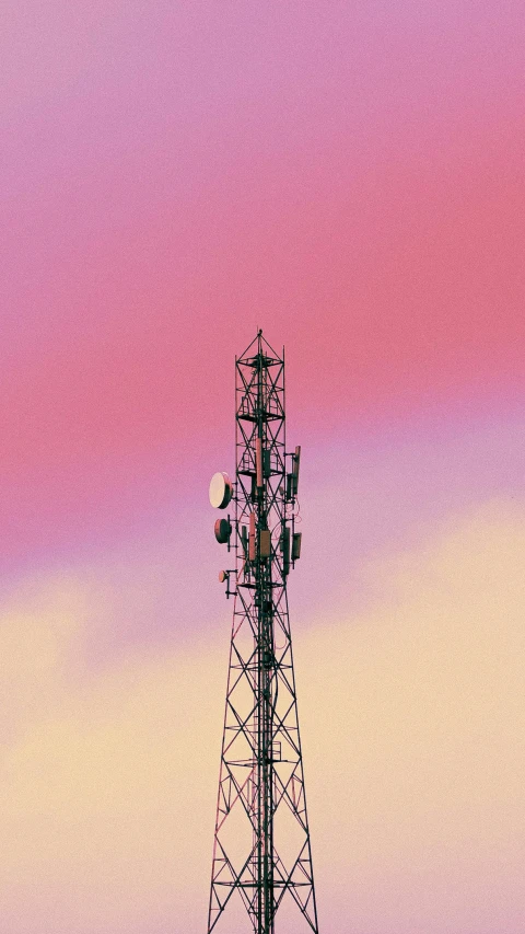 a radio tower with a cloudy sky in the background