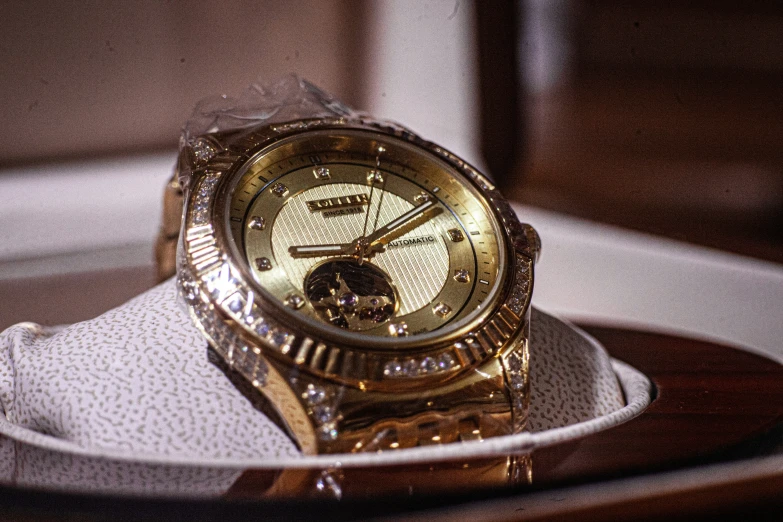 a watch sitting on top of a white sneakers