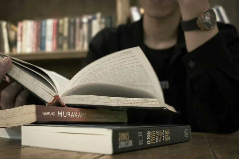 two books laying on a wooden table