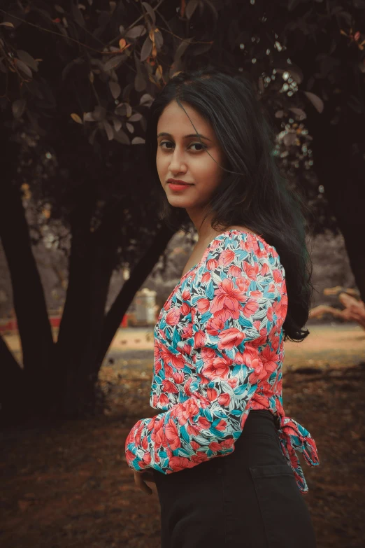 an indian woman wearing red flowers poses for a picture