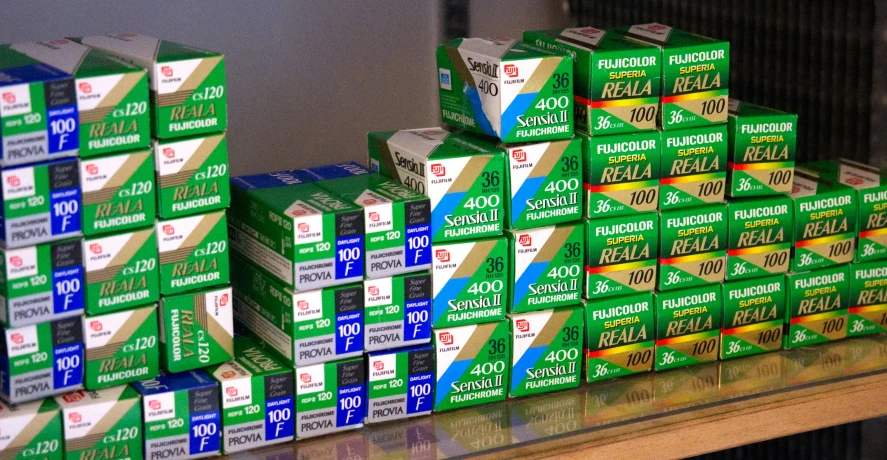 some boxes of toothpaste sitting on a shelf