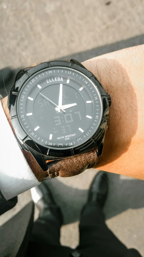 a person with a wrist watch on their left hand