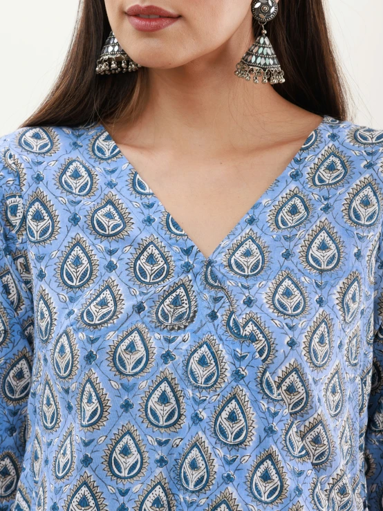 a woman wearing blue and silver jewelry