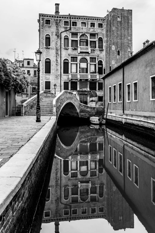 an old city with two large buildings next to water