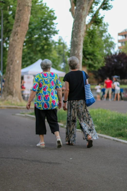 an elderly couple walking down the street