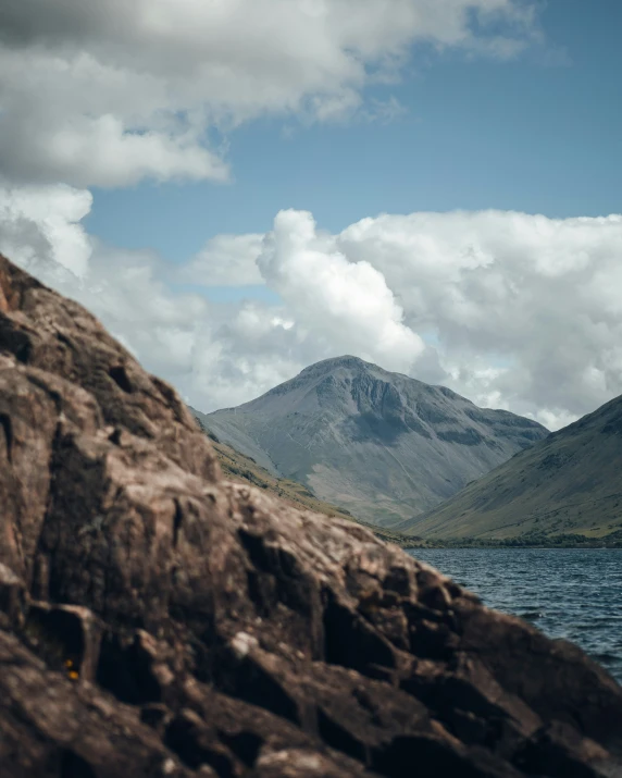 the po shows a rocky outcropping and there are mountains in the background