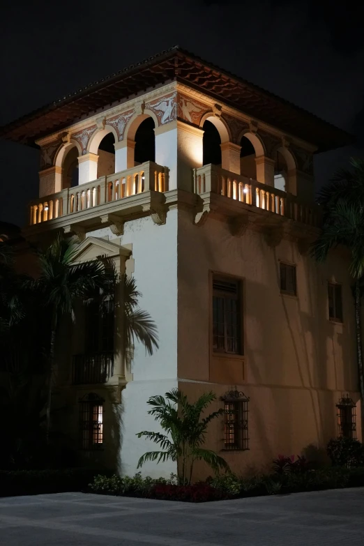 an exterior view of a building with balconies and lights