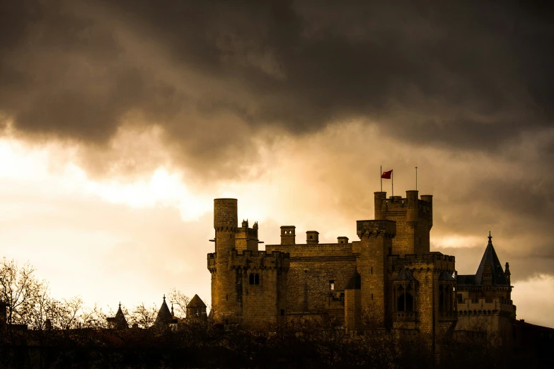 the tower of a castle under an ominous sky