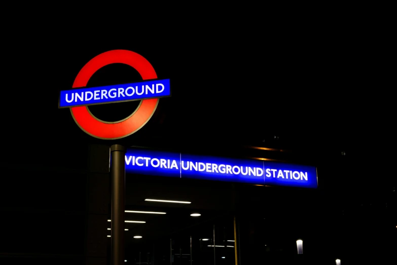 a couple of signs for victoria underground station