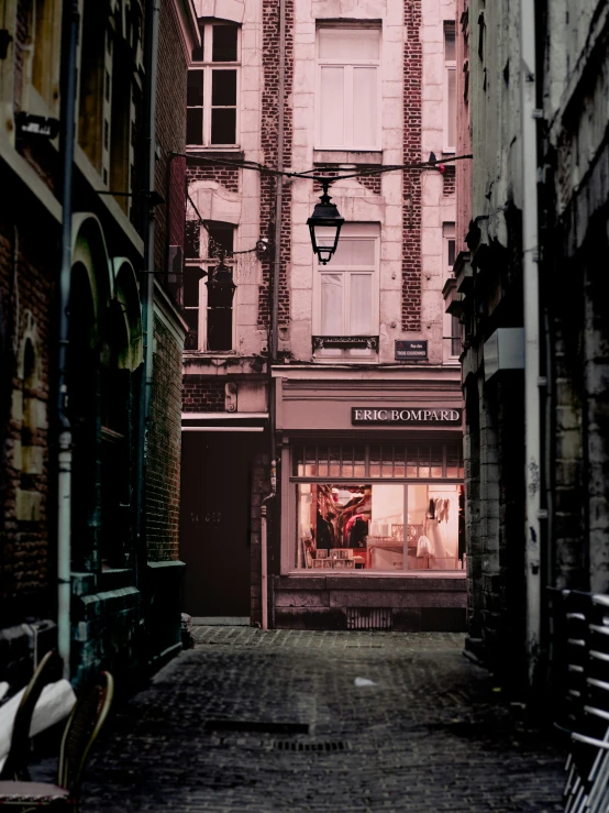 an alleyway with several shops and benches