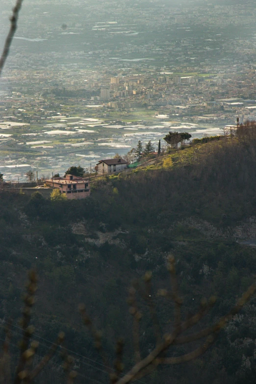 two houses sit on a hill overlooking the ocean