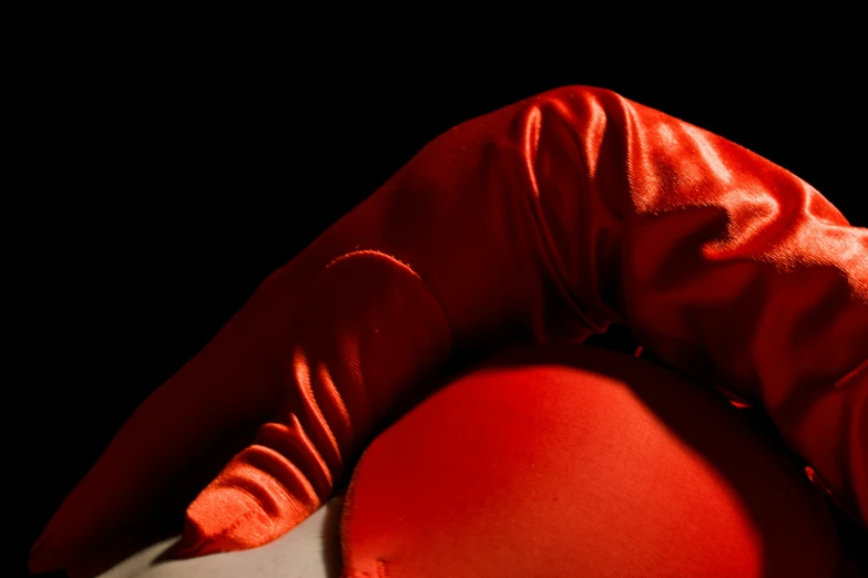 a woman with red hair and black body laying on the ground