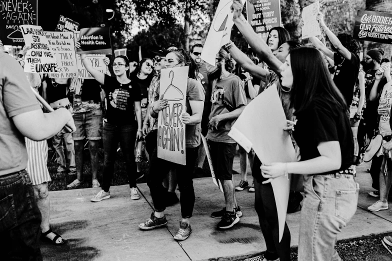 several protestors stand with signs in the street