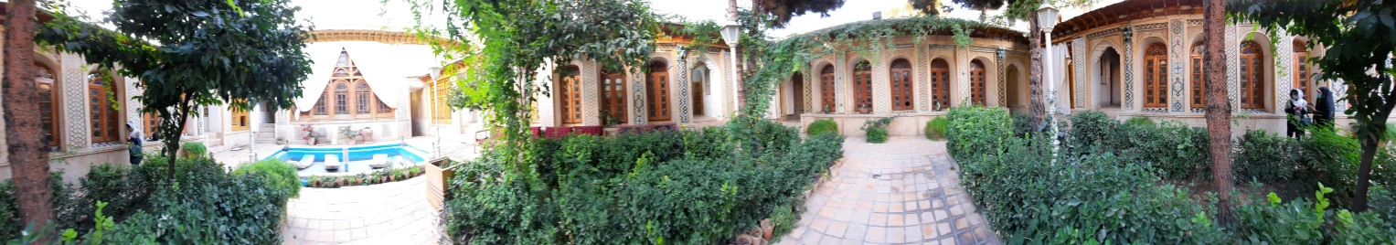 an outdoor area that features a fountain surrounded by green vines