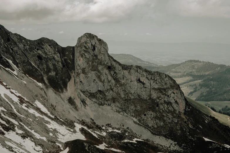 a snowy mountain covered in snow under a cloudy sky